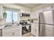 Efficient white kitchen features modern appliances, ample counter space, and a bright, clean design at 1404 N Atlantic Ave # 270, Daytona Beach, FL 32118