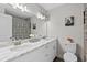 Well-lit bathroom featuring double sinks and decorative shower curtain at 5029 Sheffield Rd, Lakeland, FL 33813