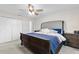 Spacious bedroom offering a cozy king-size bed, ceiling fan, and plenty of room to personalize the space at 5029 Sheffield Rd, Lakeland, FL 33813