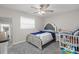 Cozy bedroom featuring gray carpet, ceiling fan, and cot at 5029 Sheffield Rd, Lakeland, FL 33813