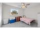 Functional bedroom with gray carpet, window view, and minimalist decor at 5029 Sheffield Rd, Lakeland, FL 33813