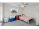 Functional bedroom with gray carpet, window view, and minimalist decor at 5029 Sheffield Rd, Lakeland, FL 33813