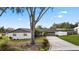 A home with a large driveway and mature landscaping at 5029 Sheffield Rd, Lakeland, FL 33813