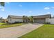 The home has a two-car garage, well-kept lawn, and a charming exterior that invites you in at 5029 Sheffield Rd, Lakeland, FL 33813