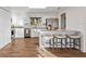 Bright kitchen with white cabinets, a granite-topped breakfast bar, and stainless steel appliances at 5029 Sheffield Rd, Lakeland, FL 33813