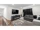 View of a cozy living room with modern furniture, including a sectional sofa and sleek entertainment center at 5029 Sheffield Rd, Lakeland, FL 33813