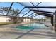 Swimming pool with a screen enclosure surrounded by backyard landscaping at 5029 Sheffield Rd, Lakeland, FL 33813