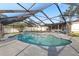 Backyard pool area with screen enclosure and lush landscaping for a private retreat at 5029 Sheffield Rd, Lakeland, FL 33813