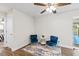 Charming sitting room with hardwood floors, blue chairs, and bright lighting at 5029 Sheffield Rd, Lakeland, FL 33813