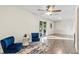 Bright sitting area with hardwood floors, two chairs, and sliding glass door at 5029 Sheffield Rd, Lakeland, FL 33813