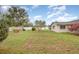 A large backyard with a white fence, storage shed, and green lawn at 5105 Se 25Th St, Ocala, FL 34480