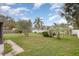 Well-maintained backyard with tropical plants and a lush green lawn at 5105 Se 25Th St, Ocala, FL 34480