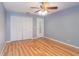 Bedroom features wood-look floors, ample closet space, ceiling fan, and lots of natural light at 5105 Se 25Th St, Ocala, FL 34480