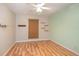 Cozy bedroom featuring a ceiling fan, bamboo shade, and stylish wood-look flooring at 5105 Se 25Th St, Ocala, FL 34480