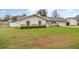 Charming single-story home featuring a well-manicured lawn and a light blue front door at 5105 Se 25Th St, Ocala, FL 34480