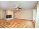 Bright living room with a brick fireplace, built-in shelving, and attractive wood-look flooring at 5105 Se 25Th St, Ocala, FL 34480