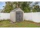 Backyard shed with gray double doors and gray roof at 5105 Se 25Th St, Ocala, FL 34480