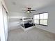 A nice carpeted bedroom featuring bunk beds, window, and ceiling fan at 6488 Sw 78Th Ct, Ocala, FL 34474