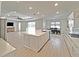 Modern kitchen featuring a large center island with sink, stainless steel appliances, and an adjacent dining area at 6488 Sw 78Th Ct, Ocala, FL 34474