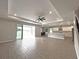 Bright and airy living room featuring wood-look tile flooring, a ceiling fan, and sliding doors to the patio at 6488 Sw 78Th Ct, Ocala, FL 34474