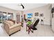 Spacious living room featuring tile flooring, neutral tones and comfortable seating at 18221 Thornhill Grand Cir, Orlando, FL 32820