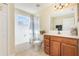 Bright bathroom featuring a shower-tub combo and a wooden vanity at 1724 Holton Rd, Lakeland, FL 33810