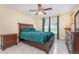 Spacious bedroom features wood furniture, a ceiling fan, and natural lighting at 1724 Holton Rd, Lakeland, FL 33810