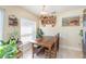 Sunlit dining area with a rustic wooden table and views of lush indoor plants at 1724 Holton Rd, Lakeland, FL 33810