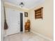 Welcoming foyer with white door and light beige tile floors at 1724 Holton Rd, Lakeland, FL 33810