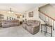 Spacious living room with tile floors, neutral colors and a staircase at 1724 Holton Rd, Lakeland, FL 33810