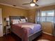 Comfortable bedroom with a ceiling fan and natural light at 2404 Waycross Ave, Eustis, FL 32726