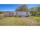 Home exterior on an overgrown lot under a clear sky at 1140 Saddlewood Blvd, Lakeland, FL 33809