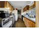 Galley kitchen with wood cabinets and appliances at 1140 Saddlewood Blvd, Lakeland, FL 33809