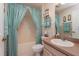 Full bathroom featuring a shower-tub combo with blue curtains and a vanity with a sink at 2009 Salinas Ave, The Villages, FL 32159