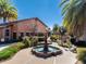 Attractive water fountain amidst lush landscaping and palm trees in a well-maintained community area at 2009 Salinas Ave, The Villages, FL 32159