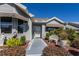 Inviting front entrance showcasing a walkway lined with manicured bushes, leading to a charming home exterior at 2009 Salinas Ave, The Villages, FL 32159