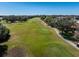 Scenic view of the community golf course with lush green fairways and mature trees at 2009 Salinas Ave, Lady Lake, FL 32159