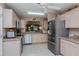 Bright kitchen with stainless steel appliances and neutral-toned cabinets at 2009 Salinas Ave, The Villages, FL 32159