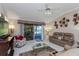 Open living area with neutral tones, ceiling fan, sliding glass doors to lanai, and comfortable furnishings at 2009 Salinas Ave, Lady Lake, FL 32159