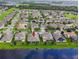 Aerial view of backyard of home overlooking a lake with a lush green lawn at 2163 Plantation Oak Dr, Orlando, FL 32824