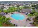 Aerial view of community pool and recreation area lined with palm trees at 2163 Plantation Oak Dr, Orlando, FL 32824