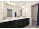 Spacious bathroom with a double sink vanity, a large mirror, and neutral tile flooring at 2163 Plantation Oak Dr, Orlando, FL 32824