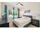 Bedroom featuring a bed with a black leather headboard, side tables and ceiling fan at 2163 Plantation Oak Dr, Orlando, FL 32824