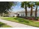 A beautifully landscaped one-story home with a two-car garage and paved driveway at 2163 Plantation Oak Dr, Orlando, FL 32824