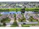 Aerial front view of a house with well-maintained lawn, landscaping, and brick-paved driveway at 2163 Plantation Oak Dr, Orlando, FL 32824