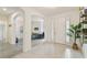 Inviting foyer featuring neutral tile flooring, arched entryways, and a view into the living spaces at 2163 Plantation Oak Dr, Orlando, FL 32824