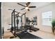 Home gym featuring a weight rack, treadmill, and mirrored wall at 2163 Plantation Oak Dr, Orlando, FL 32824