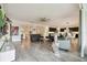 Spacious living room with modern decor, light gray floors, and an open layout connected to a modern kitchen at 2163 Plantation Oak Dr, Orlando, FL 32824