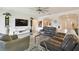 Open-concept living room featuring modern decor, light gray flooring, and arched doorways to the dining and entry areas at 2163 Plantation Oak Dr, Orlando, FL 32824