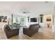 Bright living room featuring light wood floors, comfortable seating, and sliding glass doors to the lanai at 2163 Plantation Oak Dr, Orlando, FL 32824